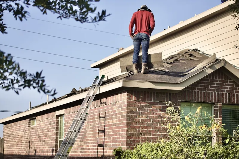 Professional roofer working on a residential roof in Sharon Hill